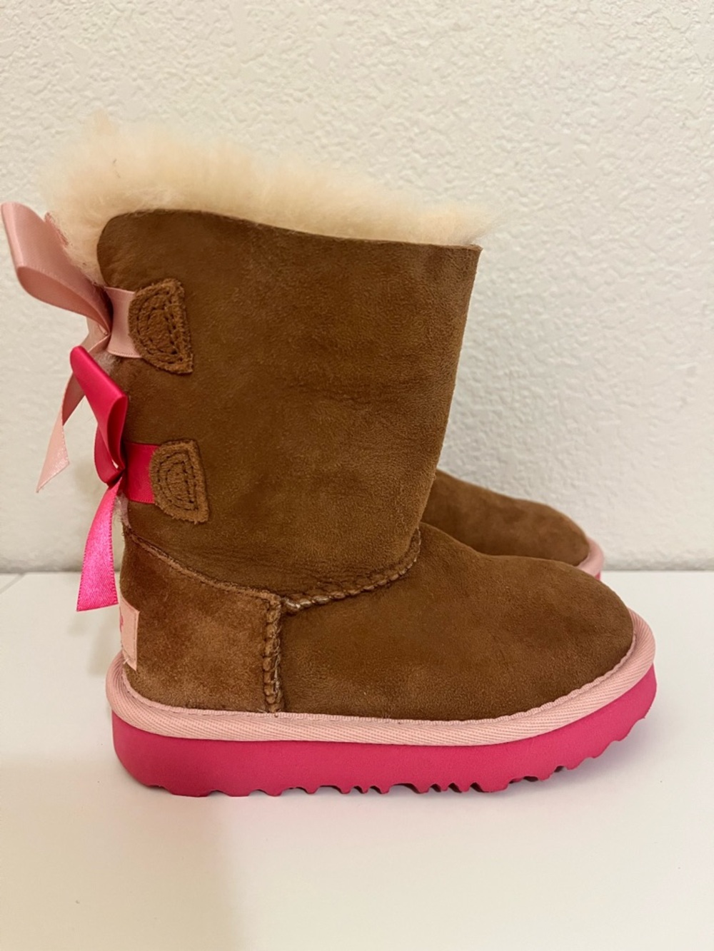Girls UGG Bailey bow Winter Boots with Pink Trim and Bows